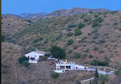 a house on the side of a mountain at Ferienhaus Casa Piedra in Sedella