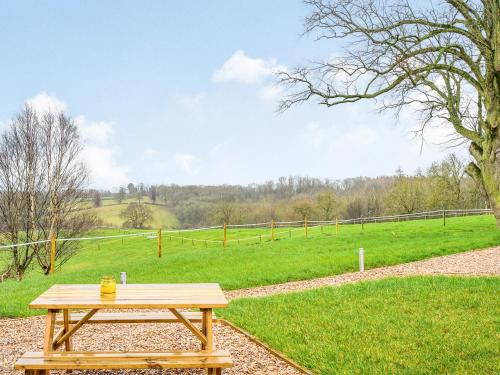 a wooden picnic table in front of a field at Holdenby - Ukc5323 in East Haddon