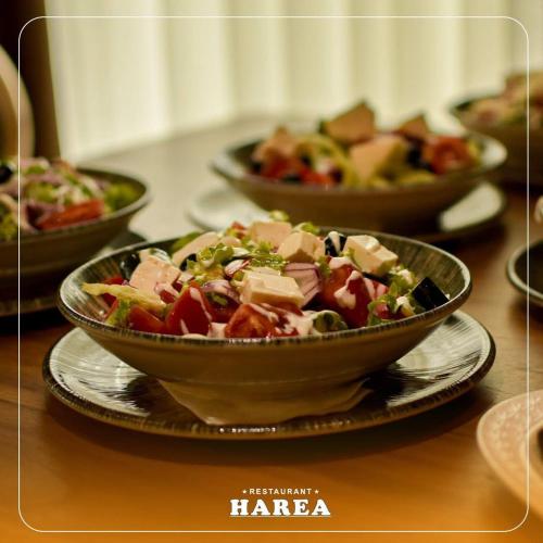 a bowl of food on a table with other bowls of food at Hotel & Restaurant HAREA in Suharekë