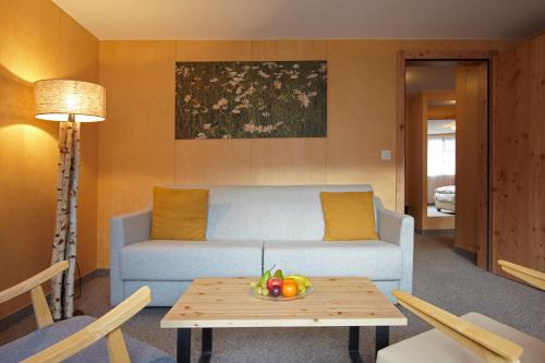 a living room with a couch and a table at Chalet Annelis Apartments in Zermatt