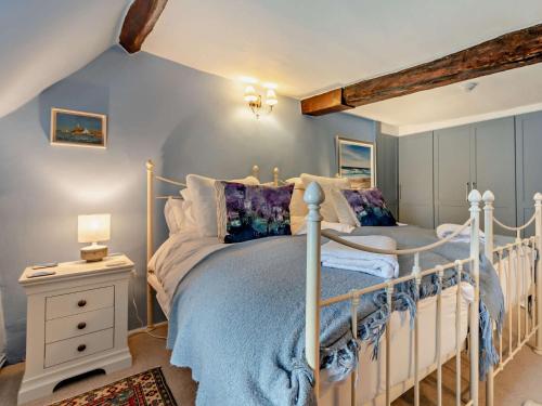 a bedroom with a white bed and a night stand at 3 bed property in Blandford Forum 83442 in Tarrant Monkton