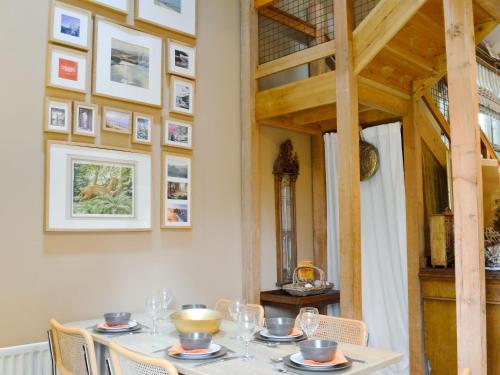 a dining room with a table with glasses on it at Arne Barn in Arne