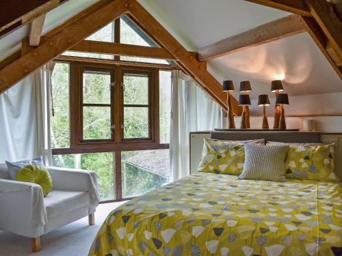 a bedroom with a yellow bed and a window at Arne Barn in Arne