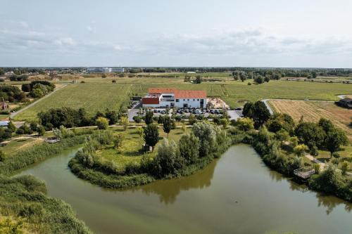 an aerial view of a house next to a river at Hotel De Zes Bochten in Knokke-Heist