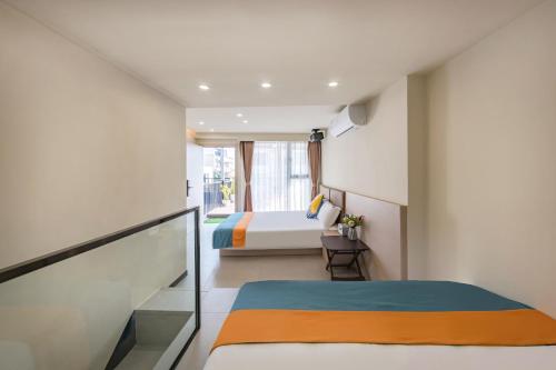 a small bedroom with a bed and a window at 厦门初默民宿 in Xiamen