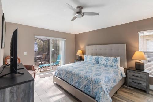 a bedroom with a bed and a flat screen tv at Vacation Home near Disney World! in Kissimmee