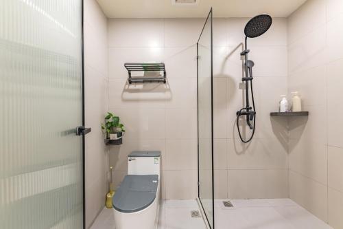 a bathroom with a shower and a toilet at 厦门初默民宿 in Xiamen