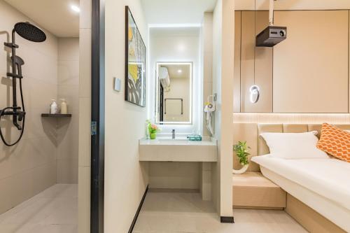 a small bathroom with a sink and a shower at 厦门初默民宿 in Xiamen