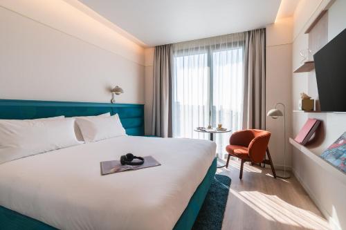 a hotel room with a bed and a chair at The Social Hub Barcelona Poblenou Extended Stay in Barcelona