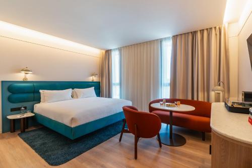 a hotel room with a bed and a table at The Social Hub Barcelona Poblenou Extended Stay in Barcelona