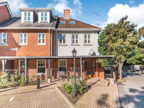 a large brick house with a porch in front of it at Forest Acorn in Brockenhurst