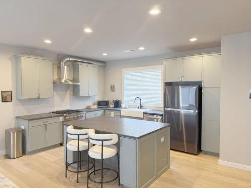 a kitchen with a large island with bar stools at 2Bd Gardener Loft Close to Silos, Clemson, Greenville in Easley