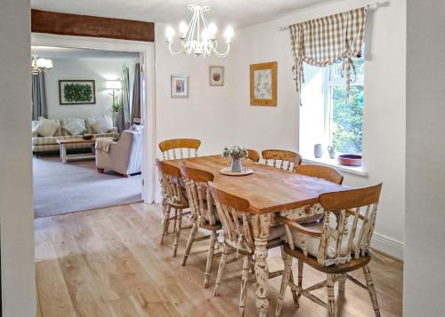 a kitchen and dining room with a wooden table and chairs at Springhouse Country Park in Slaley