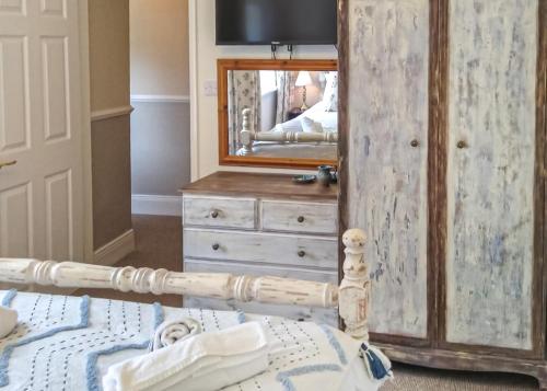 a bedroom with a dresser and a mirror at Springhouse Country Park in Slaley