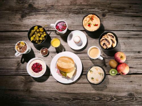 a table topped with plates of food and drinks at B&B Hotel Graz-Hbf in Graz