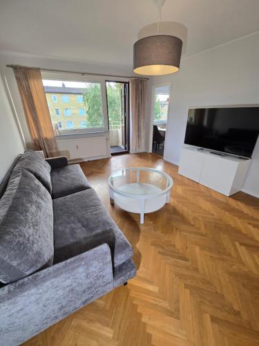 a living room with a couch and a coffee table at Bright Family Apartment with Balcony in Gothenburg