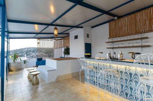 a kitchen with a counter and a bar with chairs at NJ House in Tangier