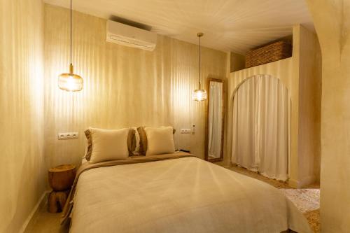 a bedroom with a large bed with two pillows at NJ House in Tangier