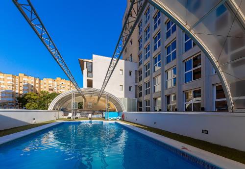 a swimming pool in the middle of a building at Vértice Sevilla in Seville