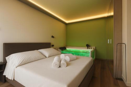 a bedroom with a bed with two towels on it at Jacuzzi Luxury Suite Iseo Elegant Apartment with Balcony Central Iseo in Iseo