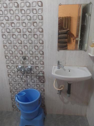 a bathroom with a blue toilet and a sink at Naksh Villa in Mahabaleshwar