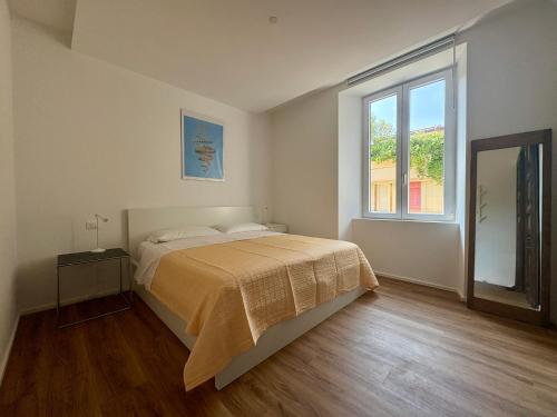 a bedroom with a bed and a large window at L'Albero in Bergamo