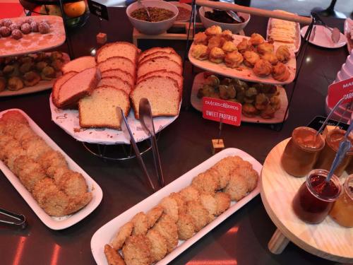 a table with many different types of food on plates at ibis Antofagasta in Antofagasta