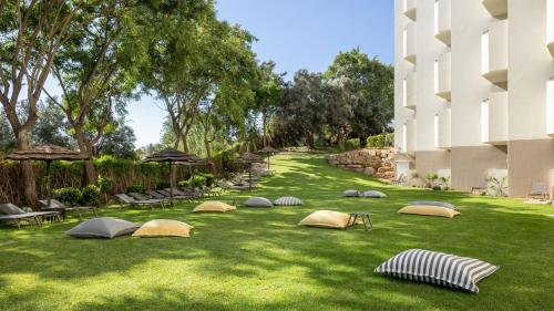 a group of tents on the grass next to a building at Holiday Inn Algarve Albufeira by IHG in Albufeira