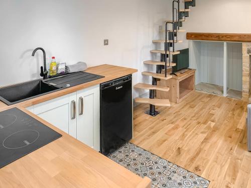 a kitchen with a sink and a dishwasher at Dovecote in Guyhirn