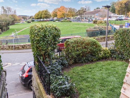 a car parked next to a fence with bushes at Whitby Bliss in Whitby