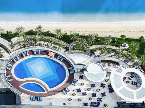 an aerial view of a resort with a swimming pool at Novotel Abu Dhabi Gate in Abu Dhabi