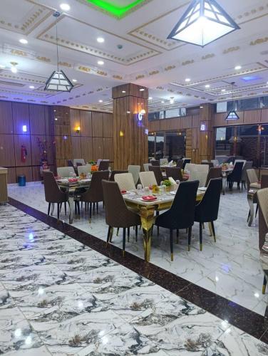 a restaurant with tables and chairs in a large room at Immaculate Excellence Luxury Hotels Ltd in Owerri