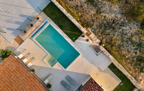 an overhead view of a swimming pool next to a house at Lovely Home In Krkovic in Prović