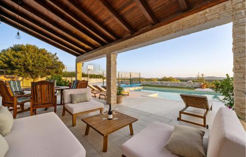 a patio with a couch and chairs and a pool at Lovely Home In Krkovic in Prović