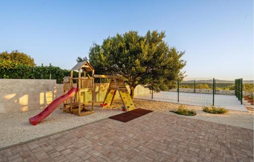 a playground with a slide and a slideintend at Lovely Home In Krkovic in Prović