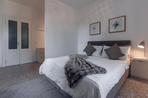 a bedroom with a bed with a fur blanket on it at Villa Elisabetta Lago Maggiore in Belgirate