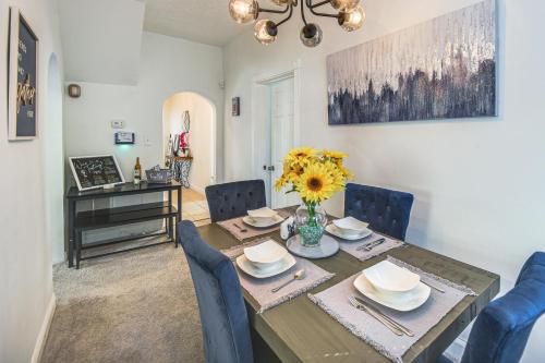 a dining room with a table and blue chairs at Spacious Family Home with Yard in Dtwn Hampton! in Hampton