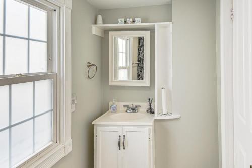 a white bathroom with a sink and a mirror at Spacious Family Home with Yard in Dtwn Hampton! in Hampton