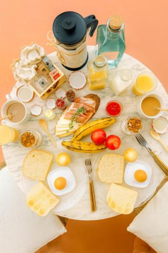 a table with eggs eggs bread and other food on it at Hotel Rural Villa del Monte in Santa Brígida