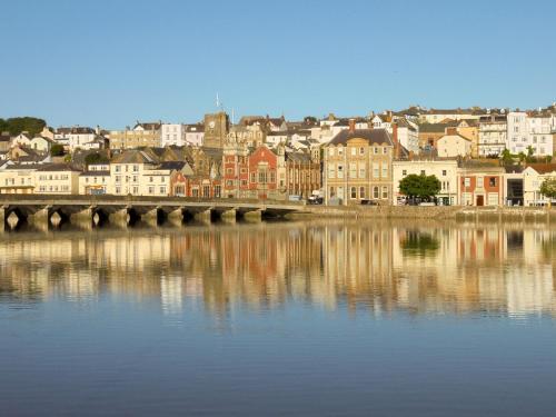 a city with a bridge over a body of water at Riverside Mews in Bideford
