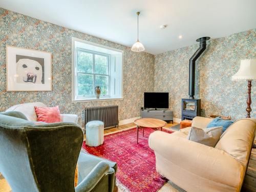 a living room with two couches and a tv at Uk47812 - Wardens Cottage in Kinloch Rannoch
