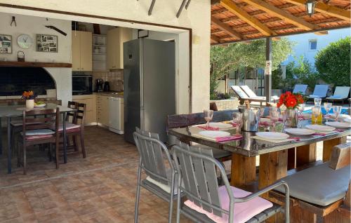a kitchen and dining room with a table and chairs at Cozy Home In Okrug Gornji With Sauna in Trogir