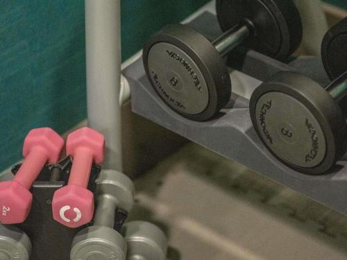 a group of dumbbells on a rack in a gym at Novotel London Brentford in Brentford