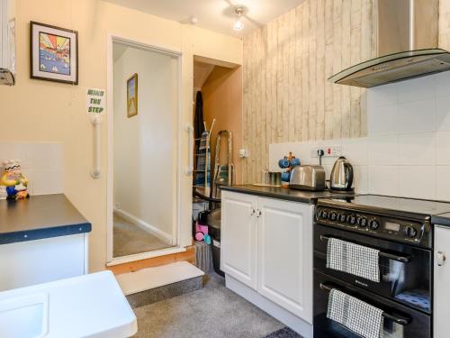 a kitchen with a stove and a sink at Hodges - Uk30761 in Gorleston-on-Sea