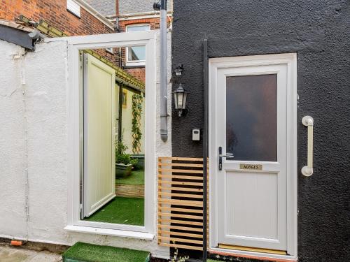 an open door of a house with a window at Hodges - Uk30761 in Gorleston-on-Sea