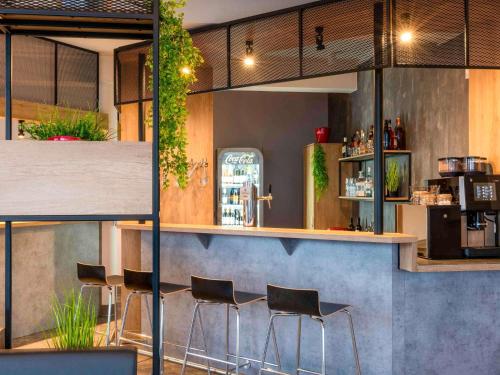 a bar with chairs and a counter in a restaurant at ibis Kassel Melsungen in Melsungen