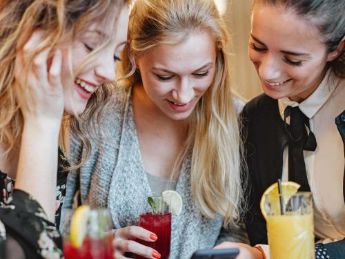 a group of three women looking at a drink at ibis Kassel Melsungen in Melsungen