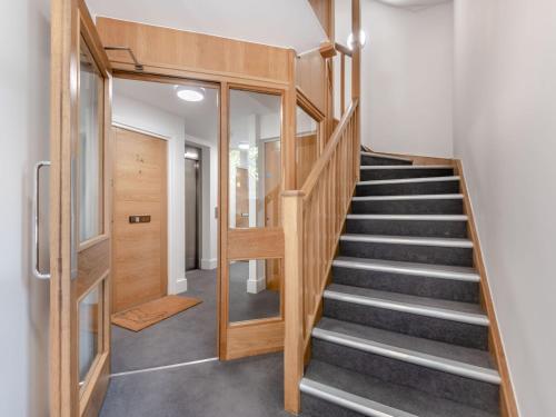 a staircase in a house with a glass door at Forest Acorn in Brockenhurst
