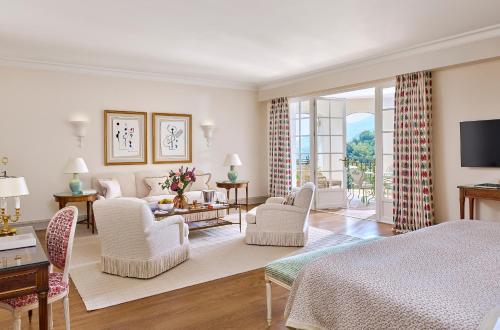 a bedroom with a bed and a living room at Château Saint-Martin & Spa, Oetker Hotels in Vence
