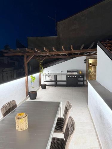 a table and chairs on a patio at night at Charming Boutique B&B Hotel in Villalfonsina